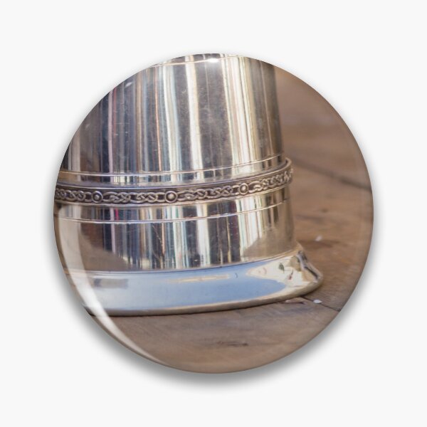 Item preview, Shiny Silver medieval mug With Decorative Band Resting On Rustic Wooden Table Scene designed and sold by Nmallia.