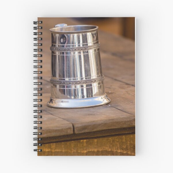 Item preview, Shiny Silver medieval mug With Decorative Band Resting On Rustic Wooden Table Scene designed and sold by Nmallia.