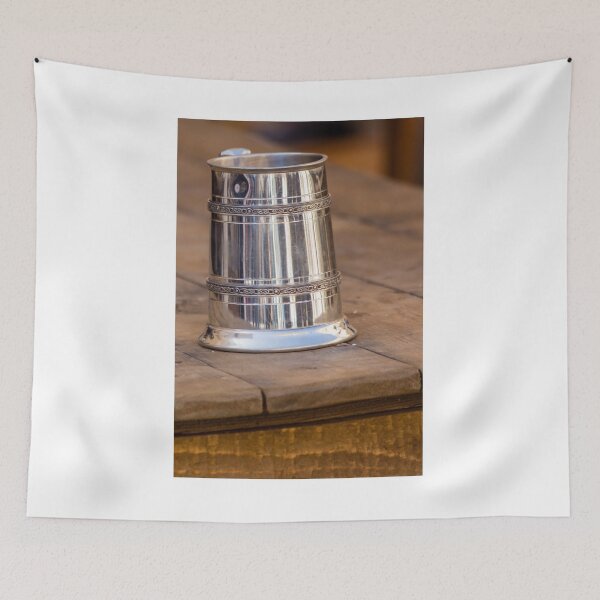 Item preview, Shiny Silver medieval mug With Decorative Band Resting On Rustic Wooden Table Scene designed and sold by Nmallia.