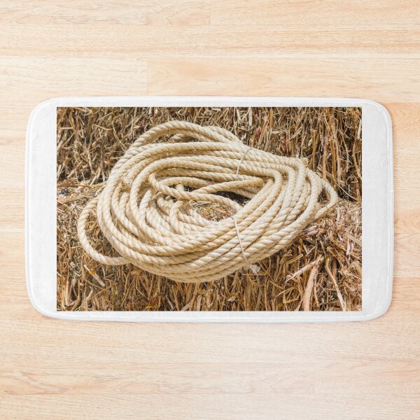 Item preview, Coiled Rope on Hay Background—Rustic Farm Scene With Thick Hemp Cord designed and sold by Nmallia.