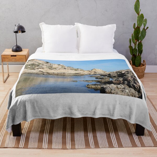 Item preview, Coastal Rock Formations and Calm Blue Water Along a Sunlit Seashore Cliffline designed and sold by Nmallia.