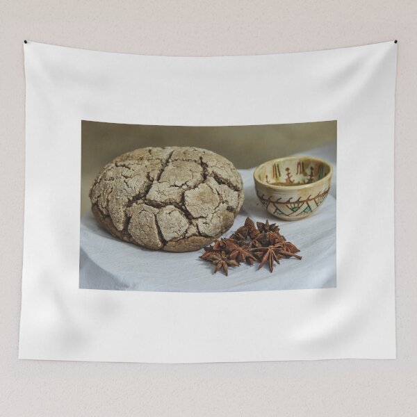 Item preview, Rustic Cracked Bread Loaf With Star Anise And Ceramic Cup On White Tablecloth designed and sold by Nmallia.
