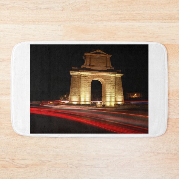 Item preview, Illuminated Stone Arch Monument At Night Surrounding Roundabout With Red Light Trails designed and sold by Nmallia.