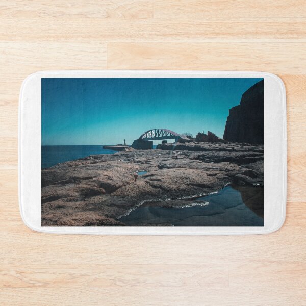 Item preview, Coastal Rocks, Bridge, and Lighthouse Over Calm Sea Under Clear Blue Sky designed and sold by Nmallia.