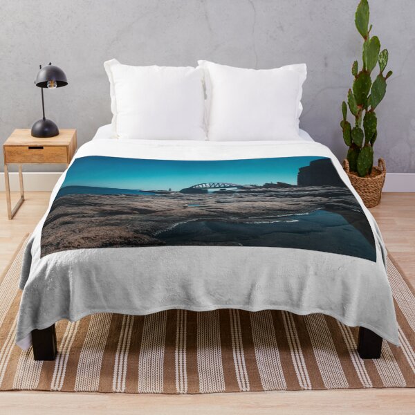 Item preview, Coastal Rocks, Bridge, and Lighthouse Over Calm Sea Under Clear Blue Sky designed and sold by Nmallia.