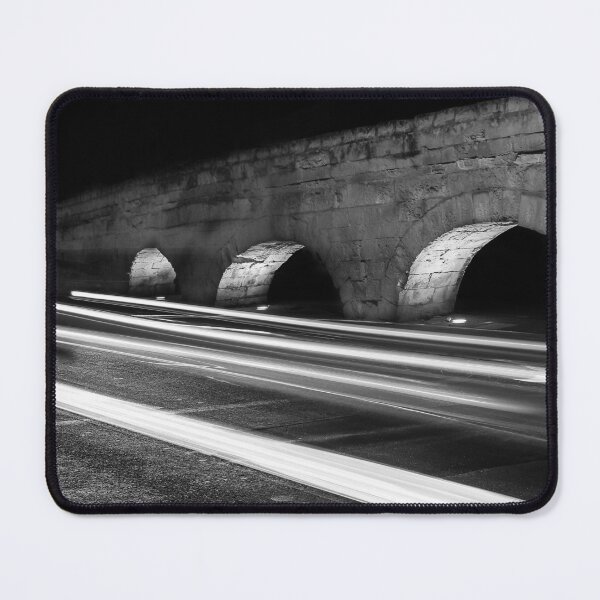 Item preview, Nighttime Stone Bridge With Arches And Light Trails Over A Quiet Urban Road designed and sold by Nmallia.