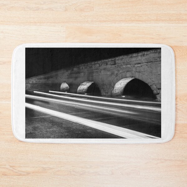 Item preview, Nighttime Stone Bridge With Arches And Light Trails Over A Quiet Urban Road designed and sold by Nmallia.