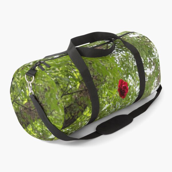 Item preview, Solitary Red Rose Against Green Treetop Leaves designed and sold by Georgia Mizuleva.