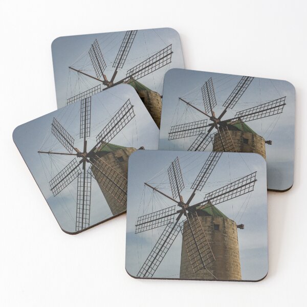 Item preview, Old Stone Windmill With Large Wooden Blades Against Clear Sky, Historic Rural Landmark designed and sold by Nmallia.