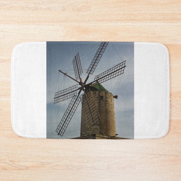 Item preview, Old Stone Windmill With Large Wooden Blades Against Clear Sky, Historic Rural Landmark designed and sold by Nmallia.