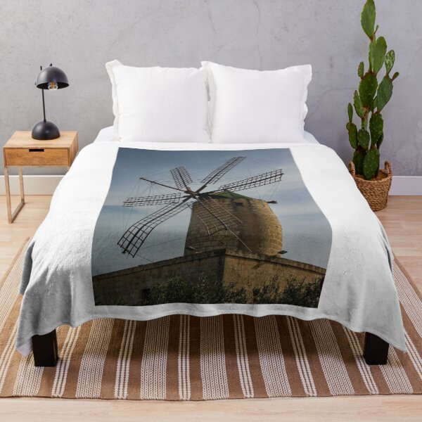 Item preview, Old Stone Windmill With Large Wooden Blades Against Clear Sky, Historic Rural Landmark designed and sold by Nmallia.