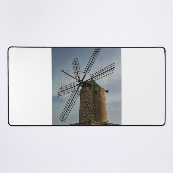 Item preview, Old Stone Windmill With Large Wooden Blades Against Clear Sky, Historic Rural Landmark designed and sold by Nmallia.