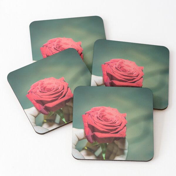 Item preview, Vibrant Deep Red Rose Held in Hand on Teal Bokeh Background designed and sold by MDB_Shop.