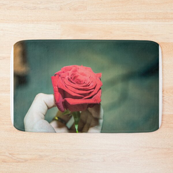 Item preview, Vibrant Deep Red Rose Held in Hand on Teal Bokeh Background designed and sold by MDB_Shop.