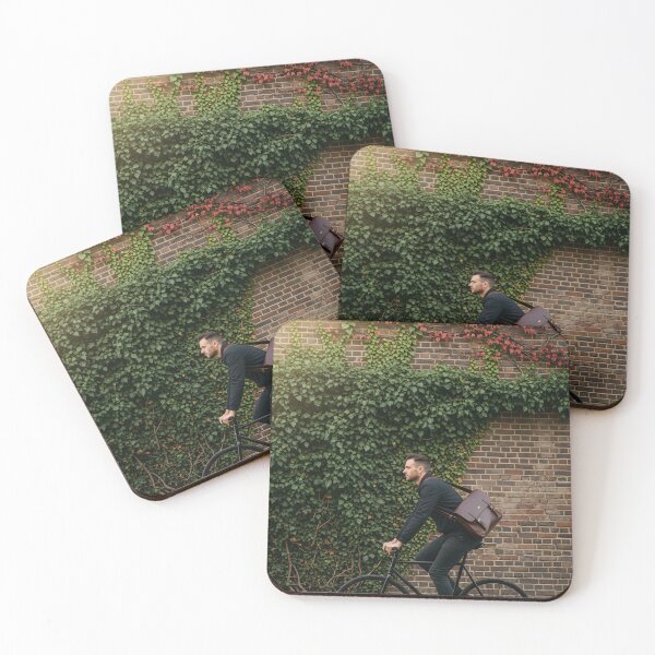 Item preview, Stylish man riding a bicycle in profile past a brick wall covered in ivy designed and sold by homydesign.
