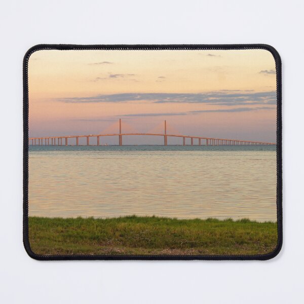 Item preview, The Sunshine Skyway Bridge stretches gracefully across Tampa Bay at dawn, bathed in soft golden light as the new day begins designed and sold by EyezWatchin.