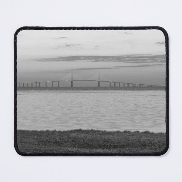 Item preview, The Sunshine Skyway Bridge stretches gracefully across Tampa Bay at dawn, bathed in soft golden light as the new day begins designed and sold by EyezWatchin.