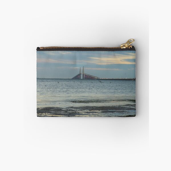 Item preview, The Sunshine Skyway Bridge stretches gracefully across Tampa Bay at dawn, bathed in soft golden light as the new day begins designed and sold by EyezWatchin.