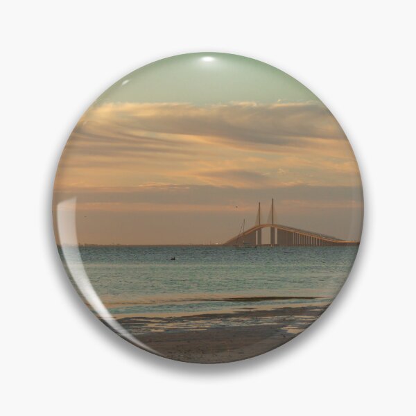 Item preview, The Sunshine Skyway Bridge stretches gracefully across Tampa Bay at dawn, bathed in soft golden light as the new day begins designed and sold by EyezWatchin.