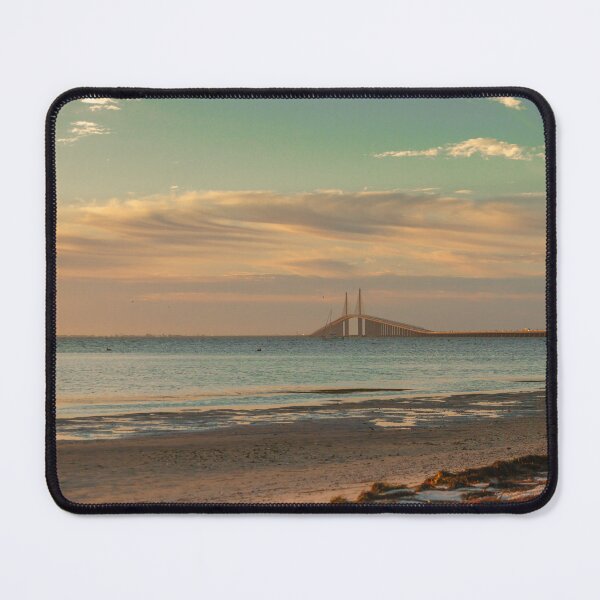 Item preview, The Sunshine Skyway Bridge stretches gracefully across Tampa Bay at dawn, bathed in soft golden light as the new day begins designed and sold by EyezWatchin.