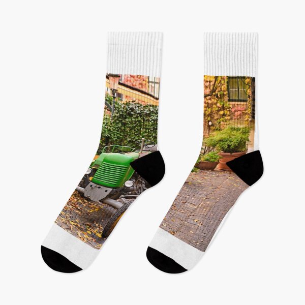 Item preview, Old green tractor in courtyard during Autumn season, Vienna, Austria  designed and sold by goceris.
