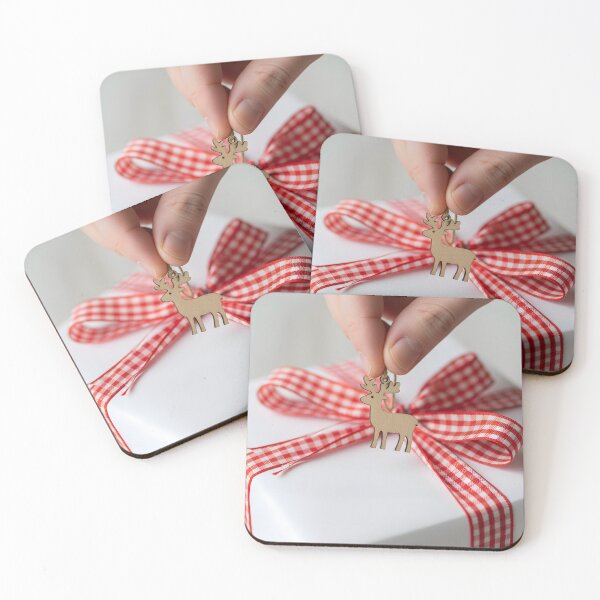 Item preview, Hand adding a wooden reindeer charm to a white wrapped gift designed and sold by homydesign.