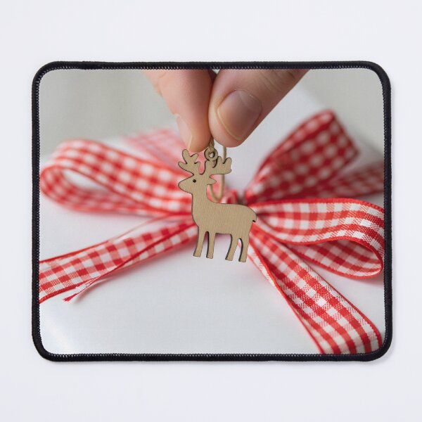 Item preview, Hand adding a wooden reindeer charm to a white wrapped gift designed and sold by homydesign.