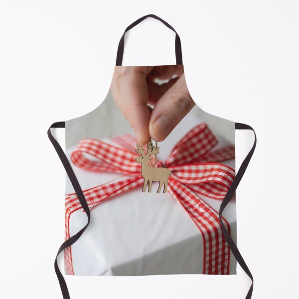 Item preview, Hand adding a wooden reindeer charm to a white wrapped gift designed and sold by homydesign.