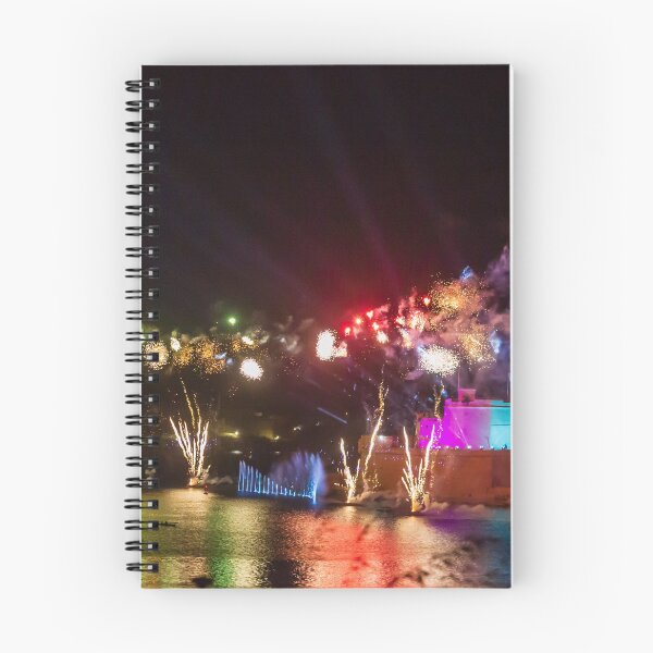 Item preview, Colorful Waterfront Fireworks Show Over Night Scene With Reflections And Illuminated Buildings designed and sold by Nmallia.