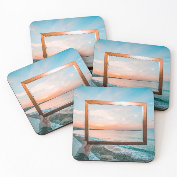 Item preview, Hand holding a wooden frame capturing a vibrant sunset view over the turquoise ocean. designed and sold by MDB_Shop.