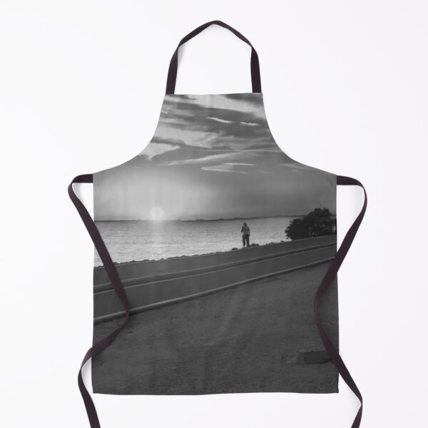 Item preview, This photo captures a powerful silhouette of a person exercising along the Howard Frankland Bridge during a vibrant sunset. designed and sold by EyezWatchin.