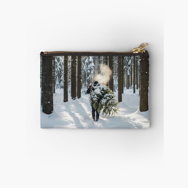 Item preview, Person Carrying a Fresh Cut Pine Tree Through a Snowy Forest designed and sold by homydesign.