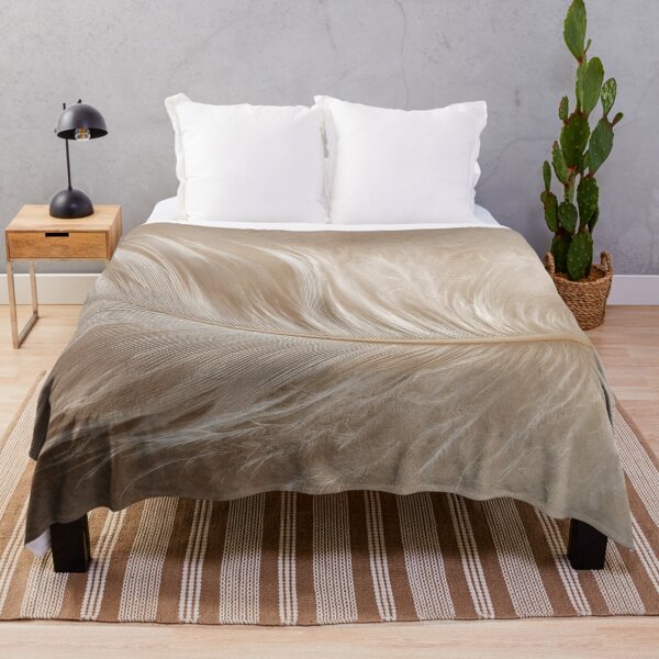 Item preview, Soft feather resting on a surface designed and sold by anytka.
