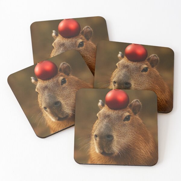 Item preview, merry capymas with a Cute Capybara with Red Christmas Ornament on Head – Funny Holiday Photo designed and sold by EmeraldeaArt.