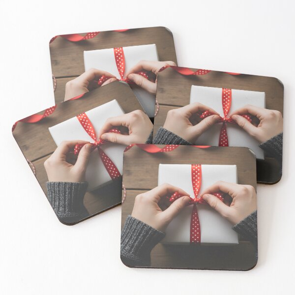 Item preview, Hands tying a polka dot red ribbon on a white gift box designed and sold by homydesign.