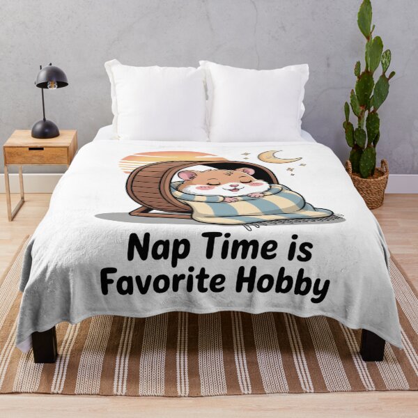 Item preview, A cartoon hamster sleeping on a running wheel with the phrase Nap time is a favorite pastime designed and sold by Pawmoods.