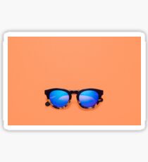 Blue lens sunglasses on an orange background Sticker