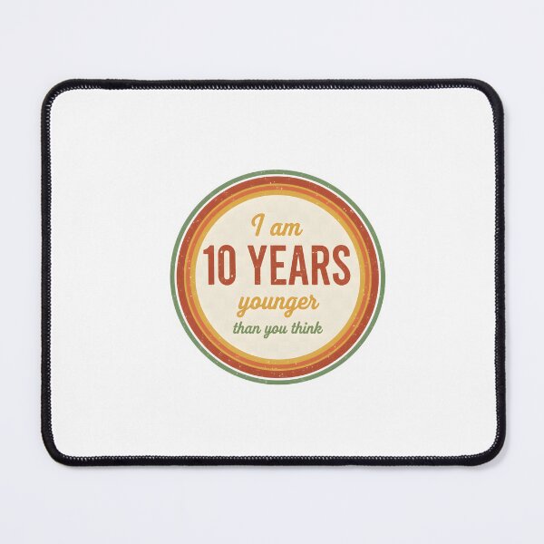 Item preview, I Am 10 Years Younger Than You Think – Retro Badge Shirt designed and sold by LoganDzign.