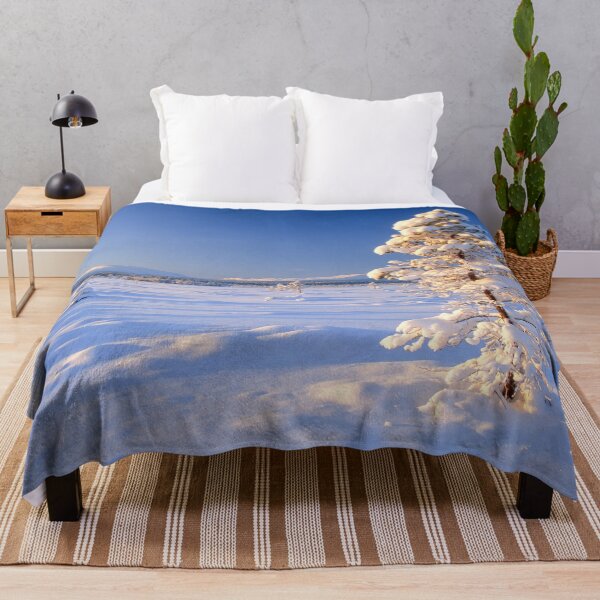 Item preview, Lone snow-covered pine tree stands in a vast, sunlit winter landscape designed and sold by Sasas Design.