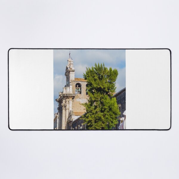 Item preview, Historic Stone Church Tower With Bells Overlooking Quiet Town Street and Green Tree Under Blue Sky designed and sold by Nmallia.
