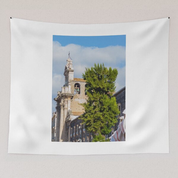 Item preview, Historic Stone Church Tower With Bells Overlooking Quiet Town Street and Green Tree Under Blue Sky designed and sold by Nmallia.