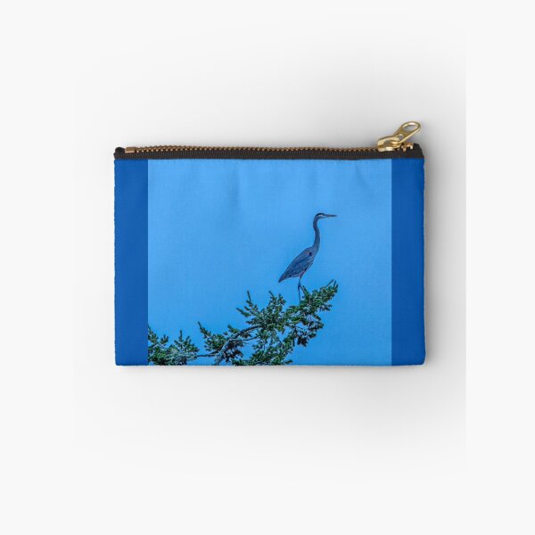 Item preview, Great Blue Heron perched on a treetop against blue evening sky designed and sold by lisavonbiela.
