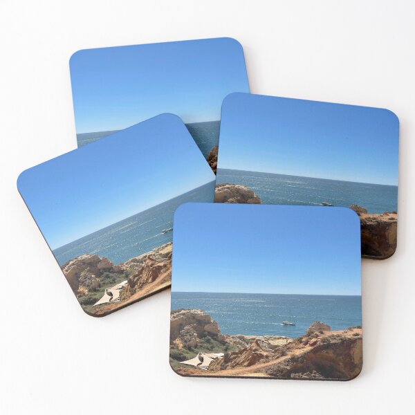 Item preview, Sailboat Between Golden Cliffs Over Deep Blue Ocean designed and sold by MatthewHeights.