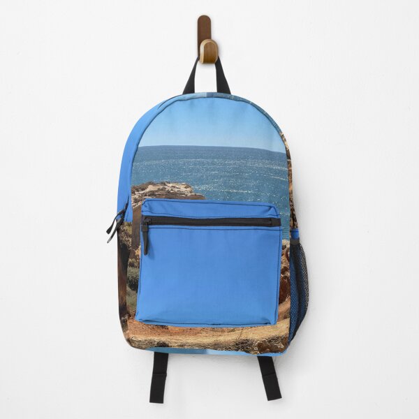 Item preview, Sailboat Between Golden Cliffs Over Deep Blue Ocean designed and sold by MatthewHeights.