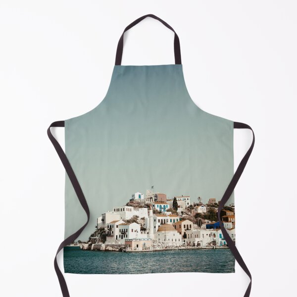 Item preview, Colorful waterfront houses on hillside in picturesque Greek island village with clear blue sea designed and sold by VasilisLens.