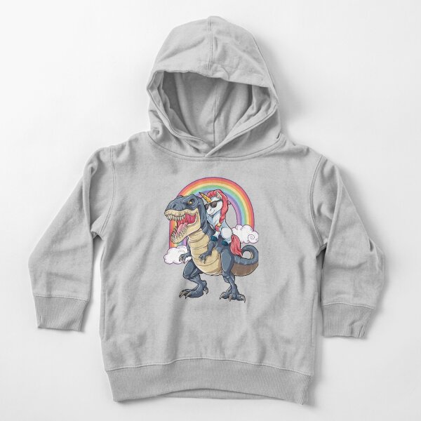 Vista previa del artículo con la obra «Camiseta con unicornio montado en dinosaurio, divertida camiseta de T-Rex, unicornios, fiesta, escuadrón arcoíris, regalos para niños, niñas y niños», diseñado y vendido por LiqueGifts.