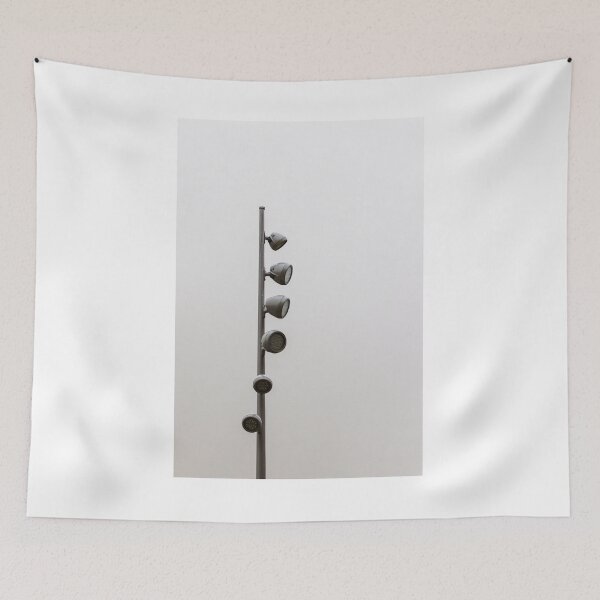 Item preview, Tall Metallic Pole With Multiple Outdoor Flood Lights Against a Cloudy Sky in an Urban Setting designed and sold by Nmallia.