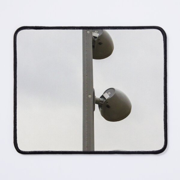 Item preview, Tall Metallic Pole With Multiple Outdoor Flood Lights Against a Cloudy Sky in an Urban Setting designed and sold by Nmallia.