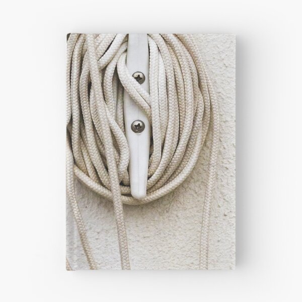 Item preview, Coiled Rope on Wall Hook With Long White Cord on Textured Wall designed and sold by Nmallia.