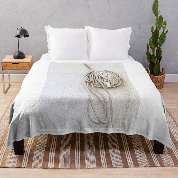 Item preview, Coiled Rope on Wall Hook With Long White Cord on Textured Wall designed and sold by Nmallia.